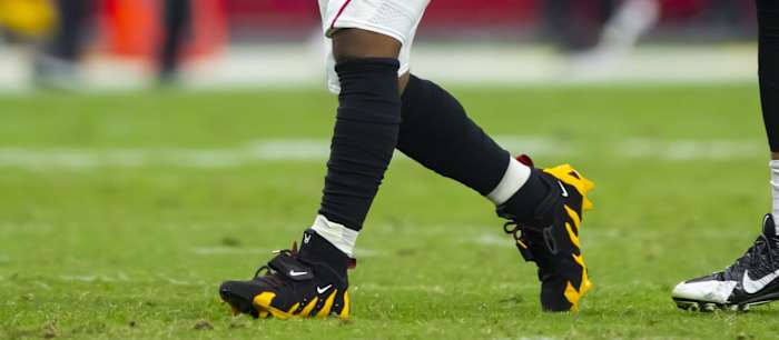 Arizona Cardinals quarterback Kyler Murray's black and gold Nike cleats.